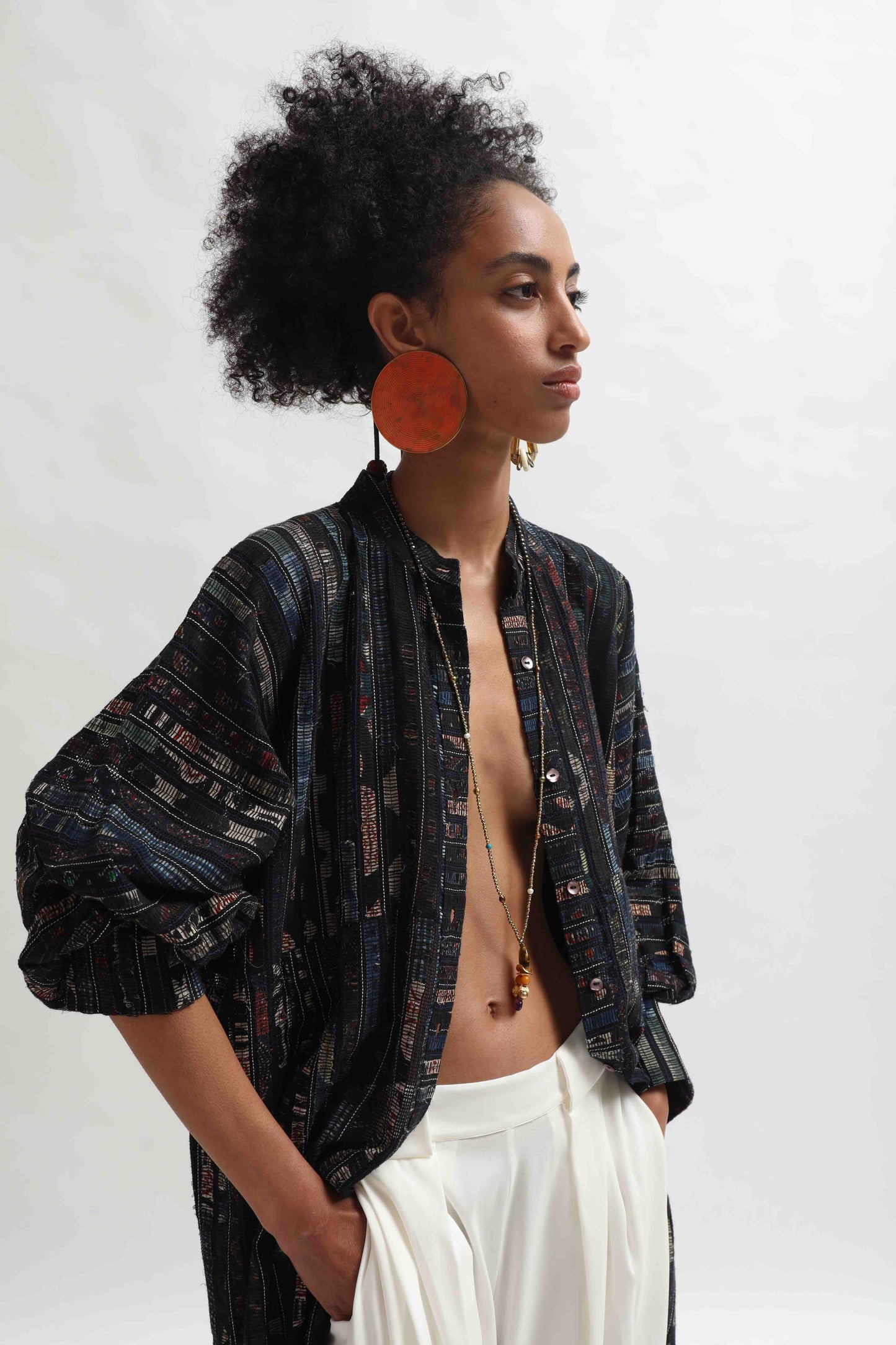 Lightweight Ajrakh Balloon Long Jacket handcrafted by Paiwand in India. Made from upcycled textile scraps with a unique leno weave and traditional handblock prints. Sustainable, ethical fashion blending heritage and innovation.