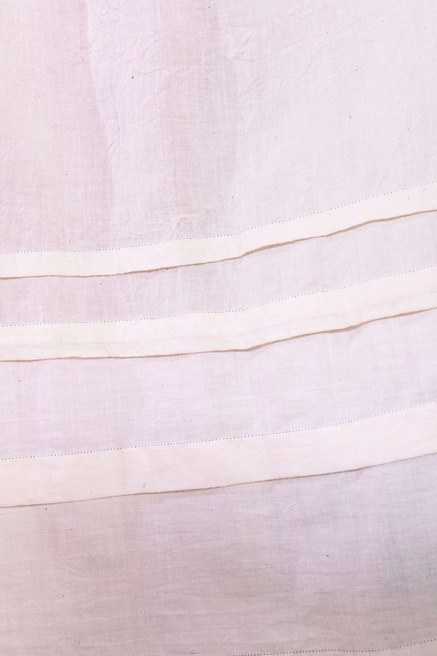 Model wearing pure cotton maxi dress by Injiri – long-sleeve off-white handloomed dress with indigo tie-dye and shibori print, side pockets, and fluid silhouette. Handcrafted in India using organic cotton.