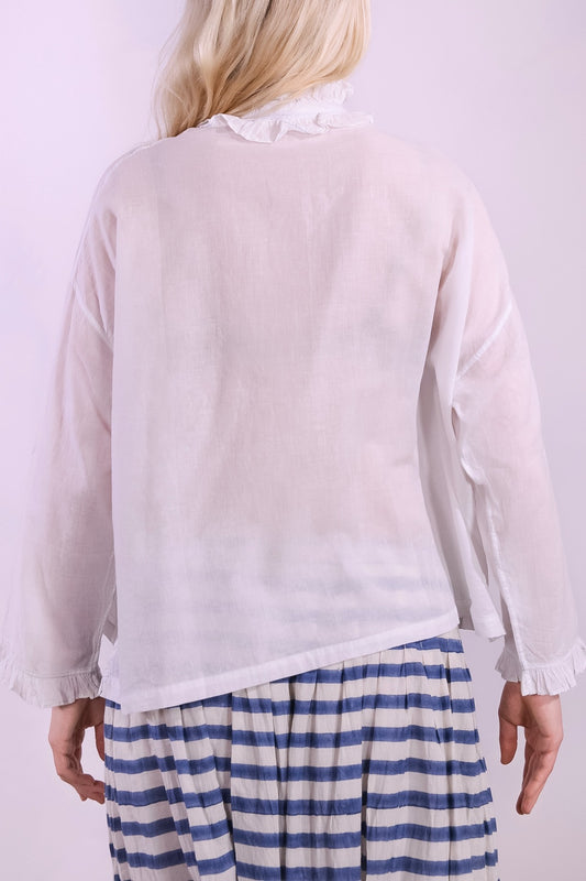 White pure cotton shirt by Injiri with cobalt ruffle stitching and yellow buttons, handmade and sustainable. Available at House of Woven Stories.