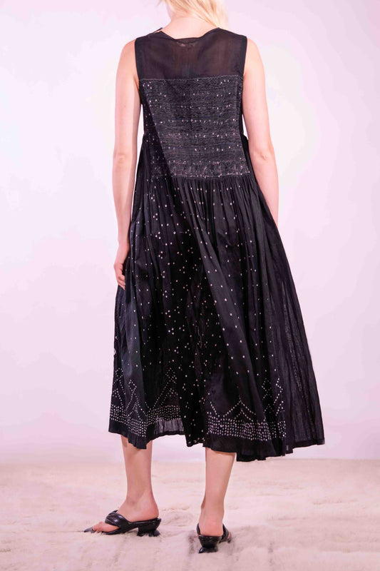 Model is wearing a long, flowing silk-cotton blend dress in black with navy and white accents. Features a softly flared skirt. Handmade in India with traditional techniques by Injiri.