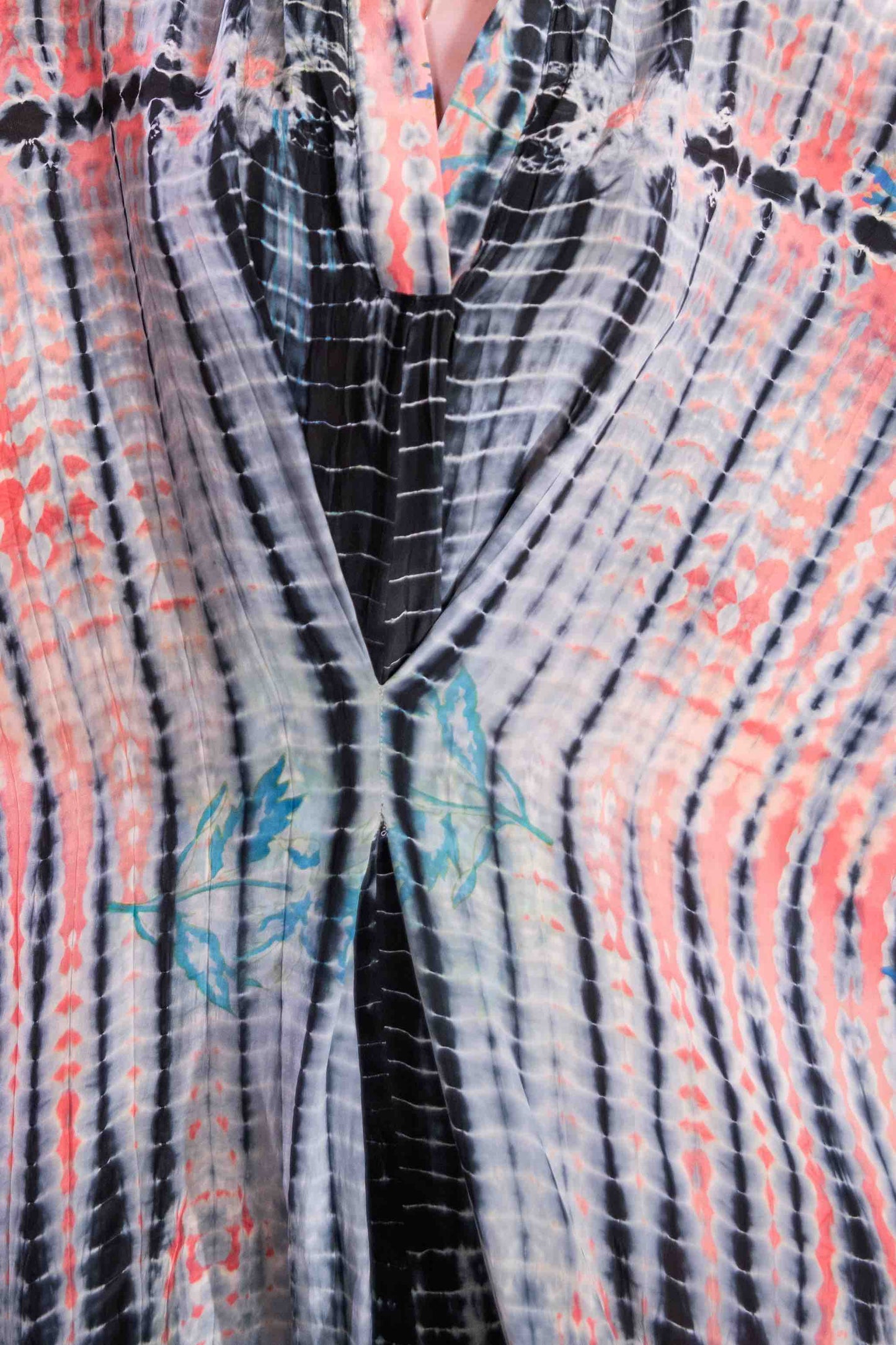 Model wearing the Barcelona Breeze Dress - a handcrafted silk dress with batwing sleeves, V-neck, and Shibori-dyed pattern, made in Italy by House of Woven Stories.