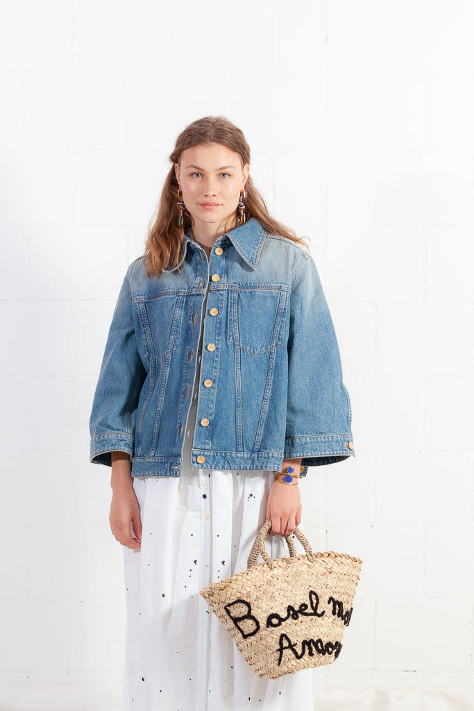 Handmade Micaela Spadoni bag with red and white striped cotton lining and Italian leather drawstring closure. Features "Basel Mon Amour" inscription in Aegean Blue. A stylish tribute to Basel. Part of Woven Stories selection.