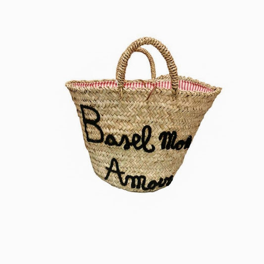 Handmade Micaela Spadoni bag with red and white striped cotton lining and Italian leather drawstring closure. Features "Basel Mon Amour" inscription in Aegean Blue. A stylish tribute to Basel. Part of Woven Stories selection.