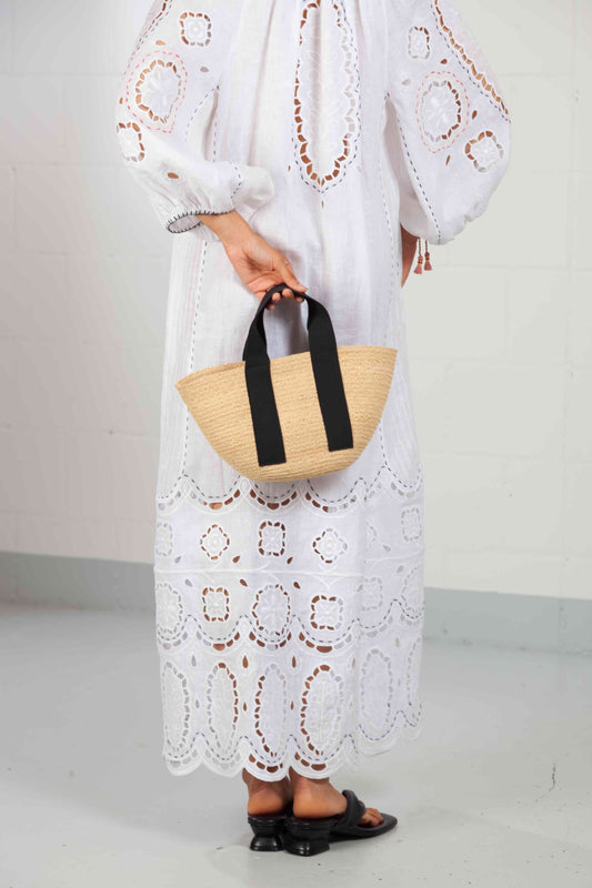 Black Mini Market raffia bag by Lola Hats with elastic handles and stitched raffia tape design. Available at House of Woven Stories.