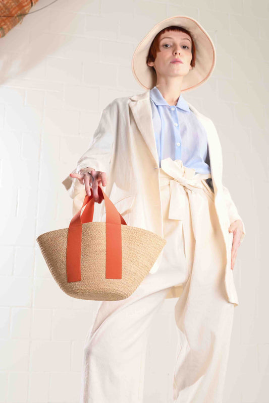 Carrot Mini Market raffia bag by Lola Hats with elastic handles and stitched raffia tape design. Available at House of Woven Stories.