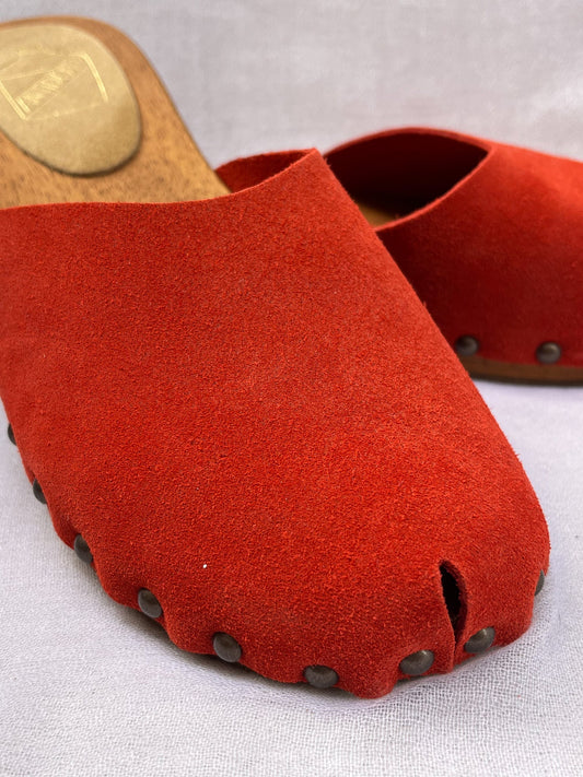 Handmade candy red clogs by Antidoti with studded sides and wooden sole, crafted in Florence, Italy. Available at House of Woven Stories.
