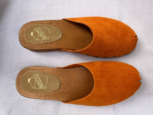 Handmade tangerine velvet clogs by Antidoti with studded sides and wooden sole, crafted in Florence, Italy. Available at House of Woven Stories.