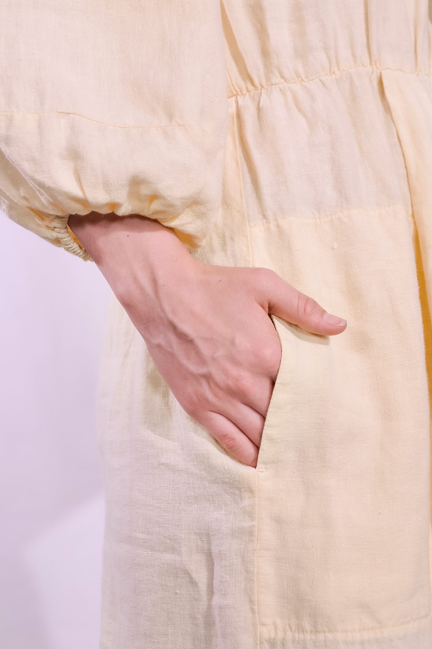 Model is wearing La Robe Bohème in banana yellow linen by Happy Haus - a timeless, feminine midi dress crafted from sustainable fabric with an effortless Parisian feel. Part of House of Woven Stories selection.