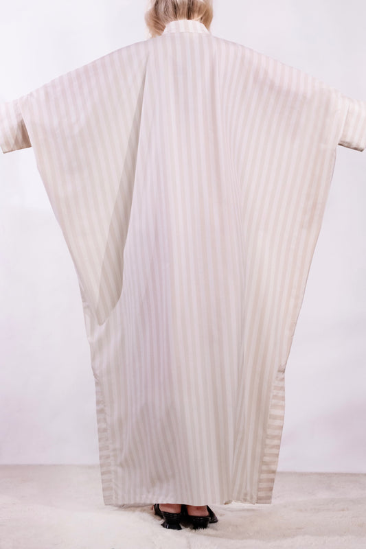 Model wearing the Fez striped shirt dress with batwing sleeves and button placket, handcrafted in Italy from 100% cotton by House of Woven Stories.
