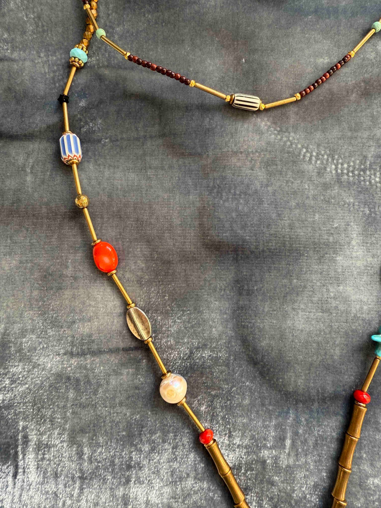 Striking handcrafted choker necklace with pyrite, pink bamboo coral, turquoise, bone inlay, and brass details. Made in Italy by Ilaria Fiorentini Jewellery. Part of the House of Woven Stories selection.