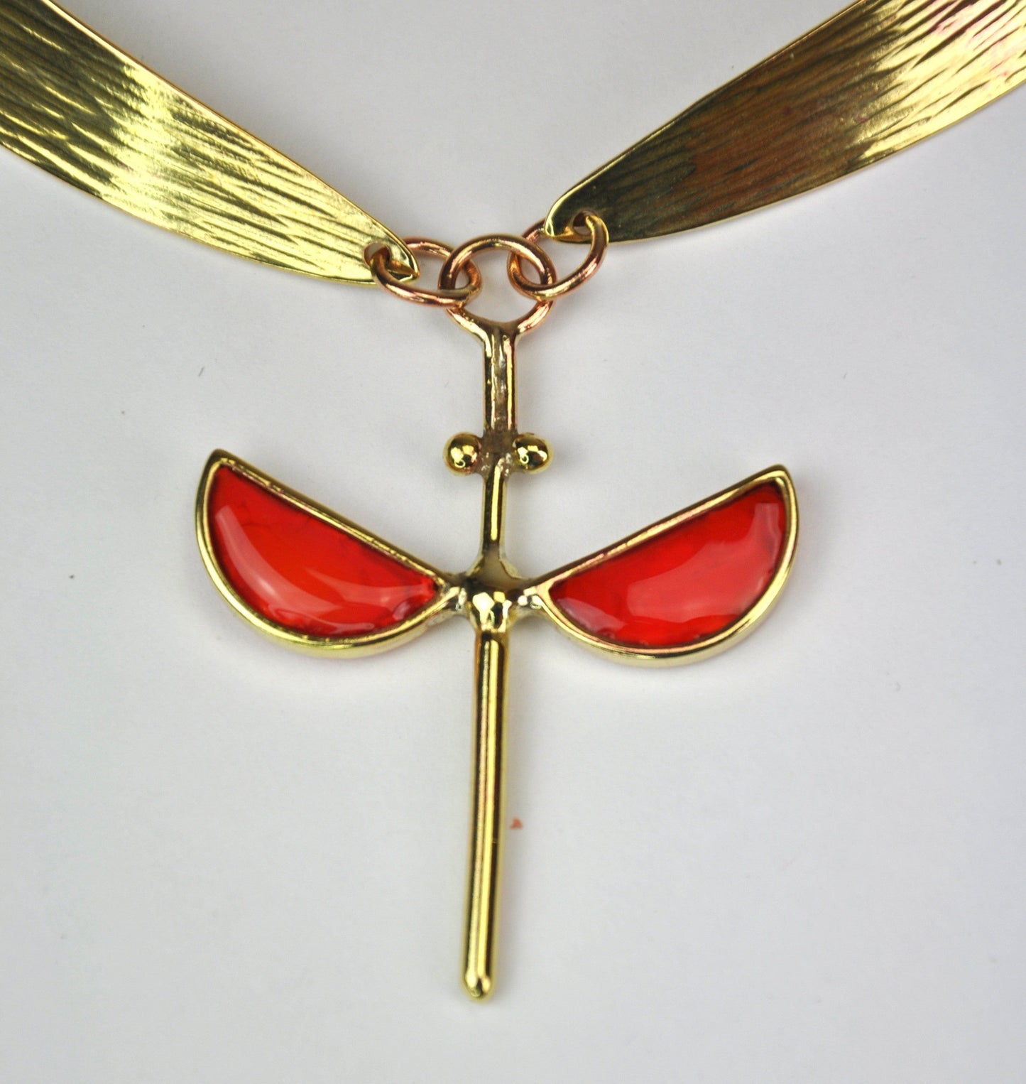 Coral hammered bronze necklace with symmetrical enamel pendant by Stéphane Szendy, handcrafted and sculptural design. Part of House of Woven Stories selection.