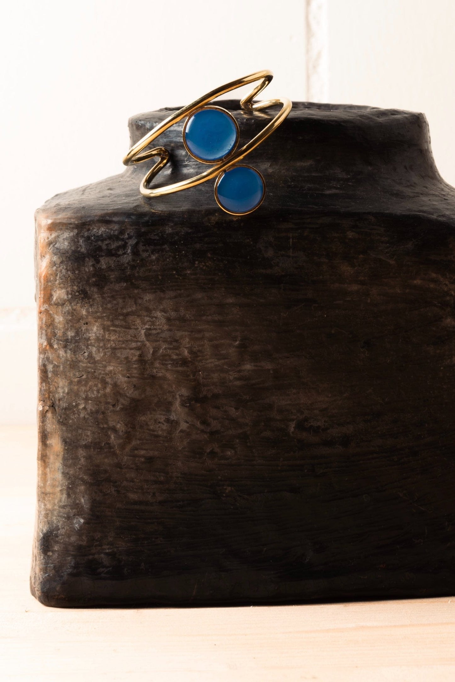Royal Blue Double Third Eye hammered bronze bracelet by Stéphane Szendy with symmetrical enamel eye motifs. By House of Woven Stories.