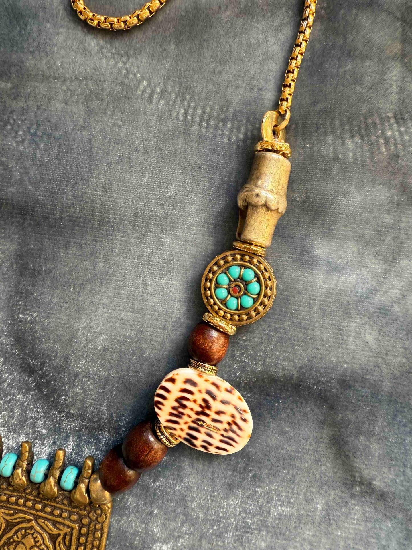 Bold handcrafted Urban Tribe Ring Square Necklace by Ilaria Fiorentini Jewellery from the House of Woven Stories selection, featuring red bamboo coral, turquoise paste, amber resin, brass and wooden details, mother-of-pearl accent, and gold-plated steel chain, inspired by African and Indonesian artisans, made in Italy.