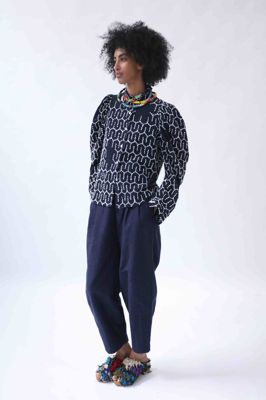 Structured puff-sleeve blouse with sharp collars and Paiwand’s signature upcycled embroidery on organic indigo-dyed cotton, handcrafted in India combining traditional craftsmanship with sustainable, modern fashion.