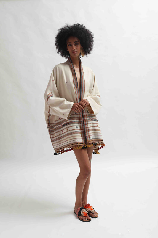 Model wearing the Kyoto Kimono Jacket in off-white handwoven merino wool with natural indigo patterns, lined in pure silk. Oversized fit, artisanal details, and bohemian elegance by House of Woven Stories.