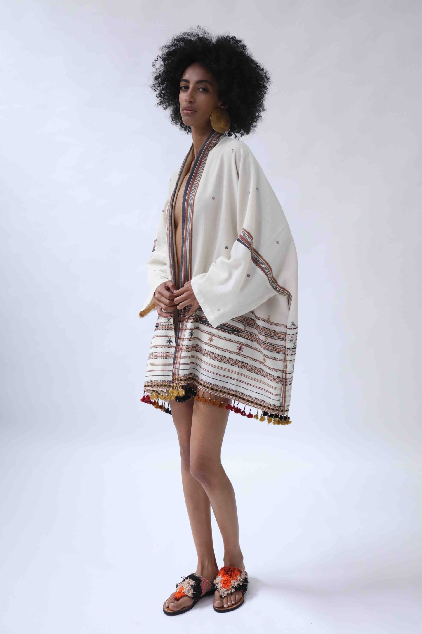 Model wearing the Kyoto Kimono Jacket in off-white handwoven merino wool with natural indigo patterns, lined in pure silk. Oversized fit, artisanal details, and bohemian elegance by House of Woven Stories.