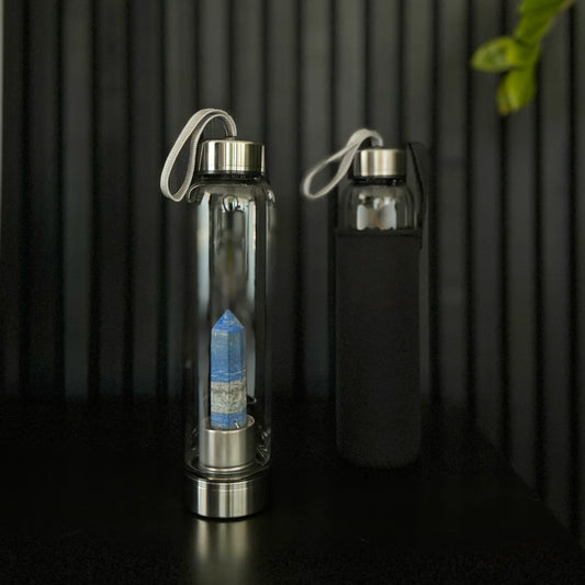Lapis Lazuli Crystal Water Bottle by The Goddess Collective, featuring a natural crystal obelisk inside a glass bottle with stainless steel lids and carry sleeve. Available at House of Woven Stories.