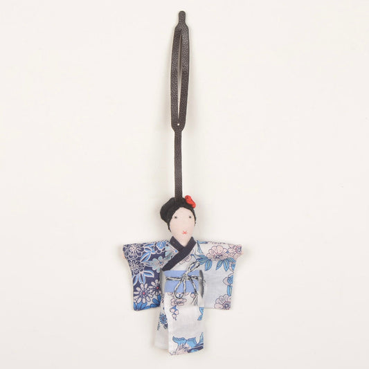 Mizu kimono fabric charm handcrafted by Afghan women artisans, shown attached to a bag, made from upcycled fabric with traditional kimono design and pink rose detail.