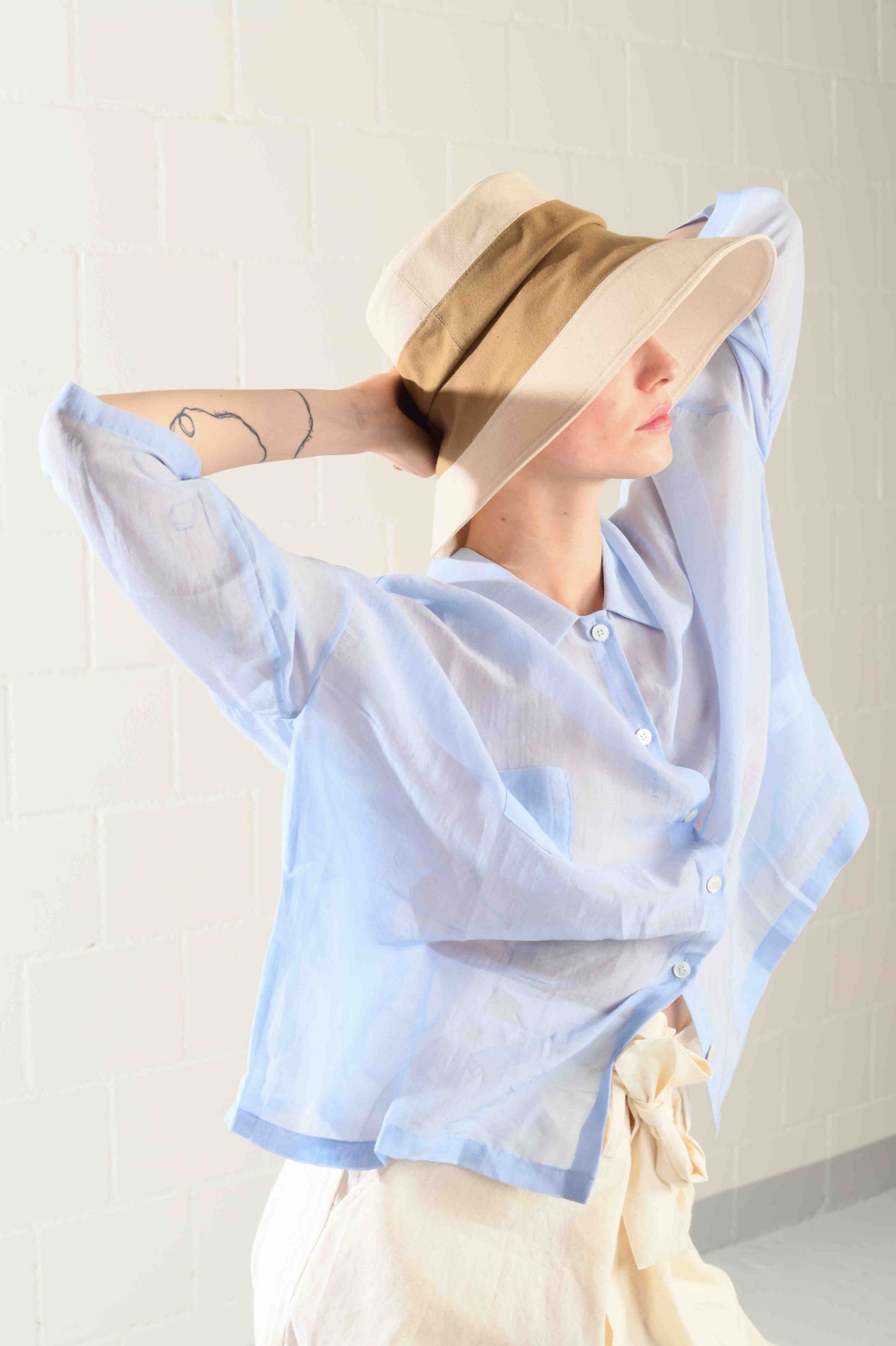 Medium-brimmed cotton fedora hat by Lola Hats, designed for travel and breezy weather, handcrafted in Brooklyn. Available at House of Woven Stories.