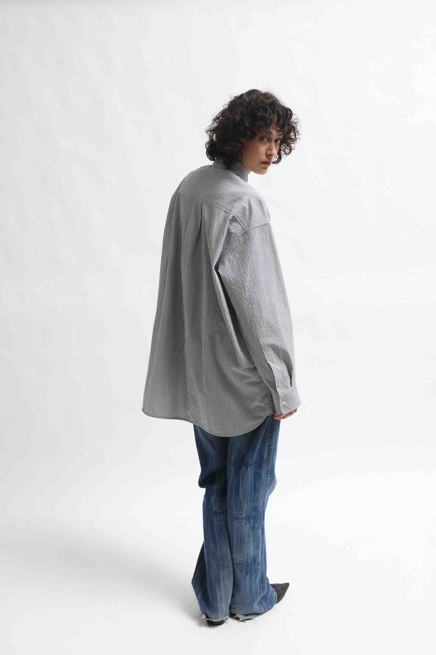 Crisp 100% organic cotton shirt with classic collar and marine blue and white stripes, handcrafted by House of Woven Stories in Italy’s Piedmont region, featuring a soft paper-touch finish and relaxed fit for versatile, refined style.