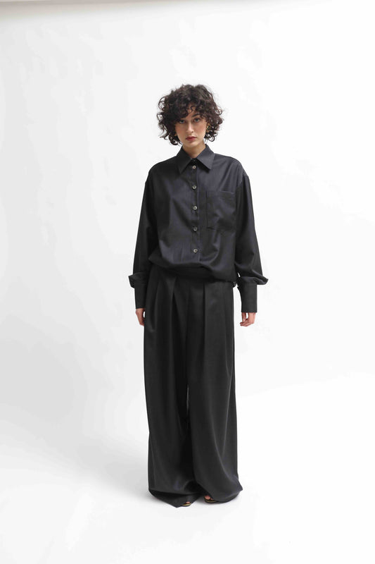 Wide-leg cool wool trousers in 100% Super 100 Pure Merino Wool with elastic waistband and front pleats, handmade in Italy by House of Woven Stories, shown in Anthracite.