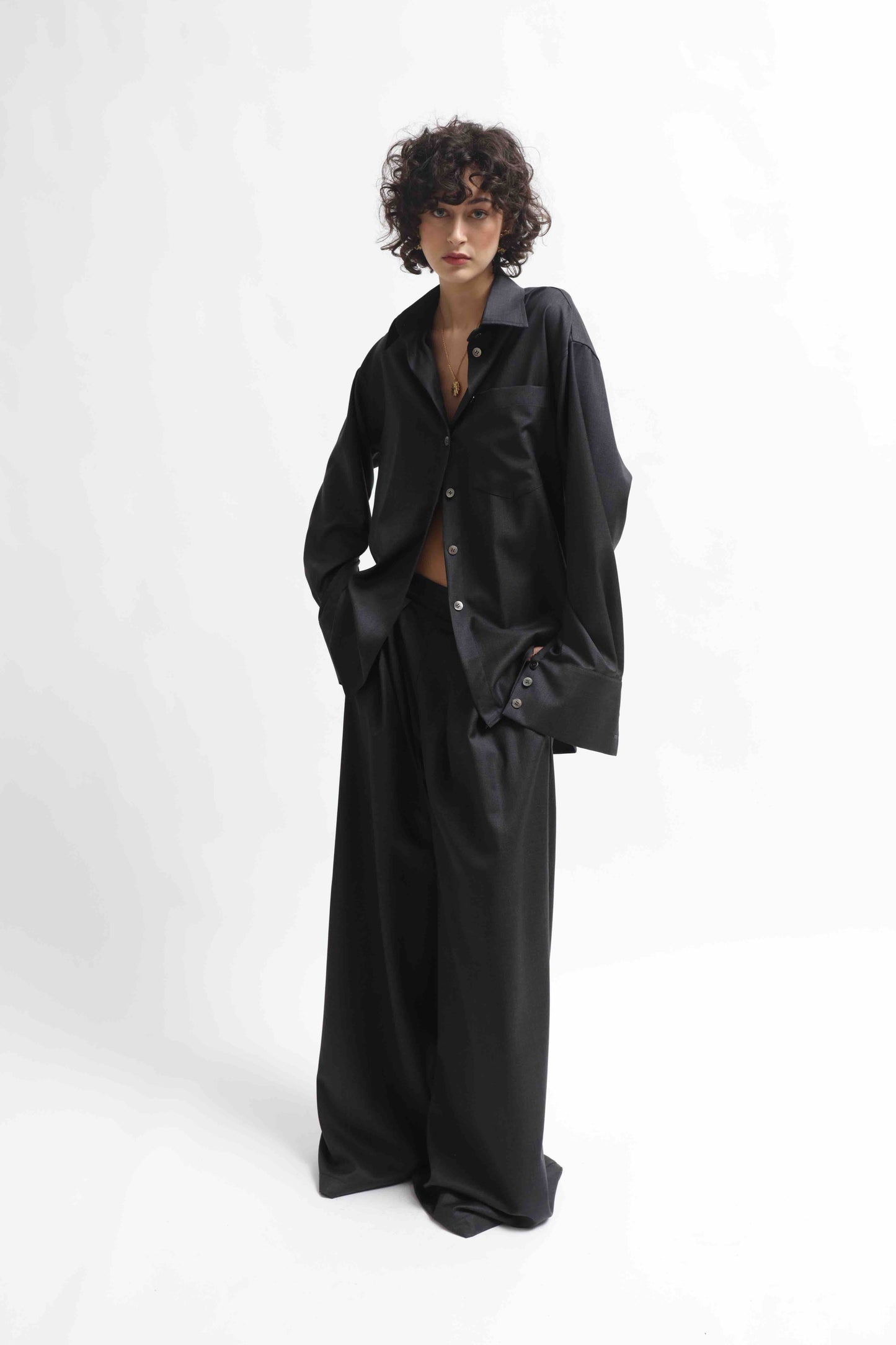 Wide-leg cool wool trousers in 100% Super 100 Pure Merino Wool with elastic waistband and front pleats, handmade in Italy by House of Woven Stories, shown in Anthracite.