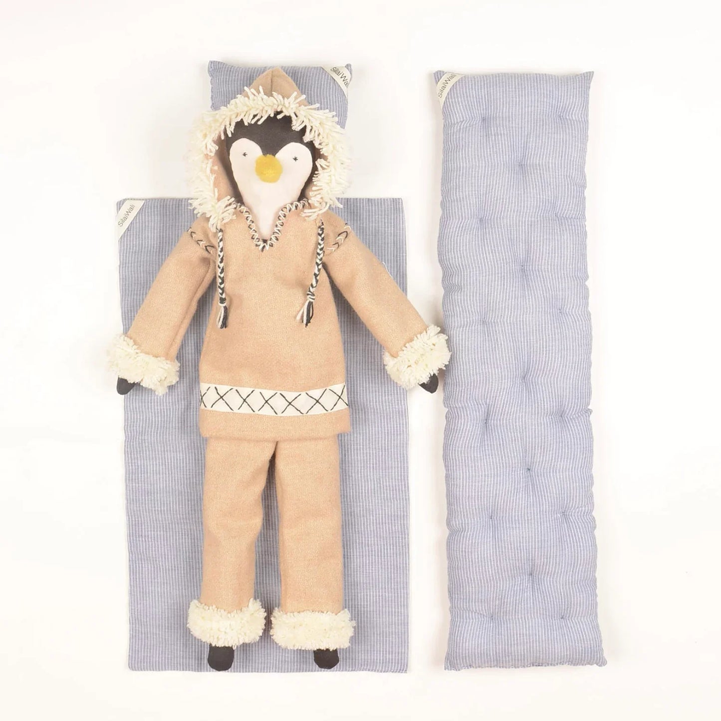 Handcrafted Patuk the Penguin soft toy made from upcycled fabric, created by Afghan refugee women artisans through SilaiWali, with bedding included in a foldable gift box.