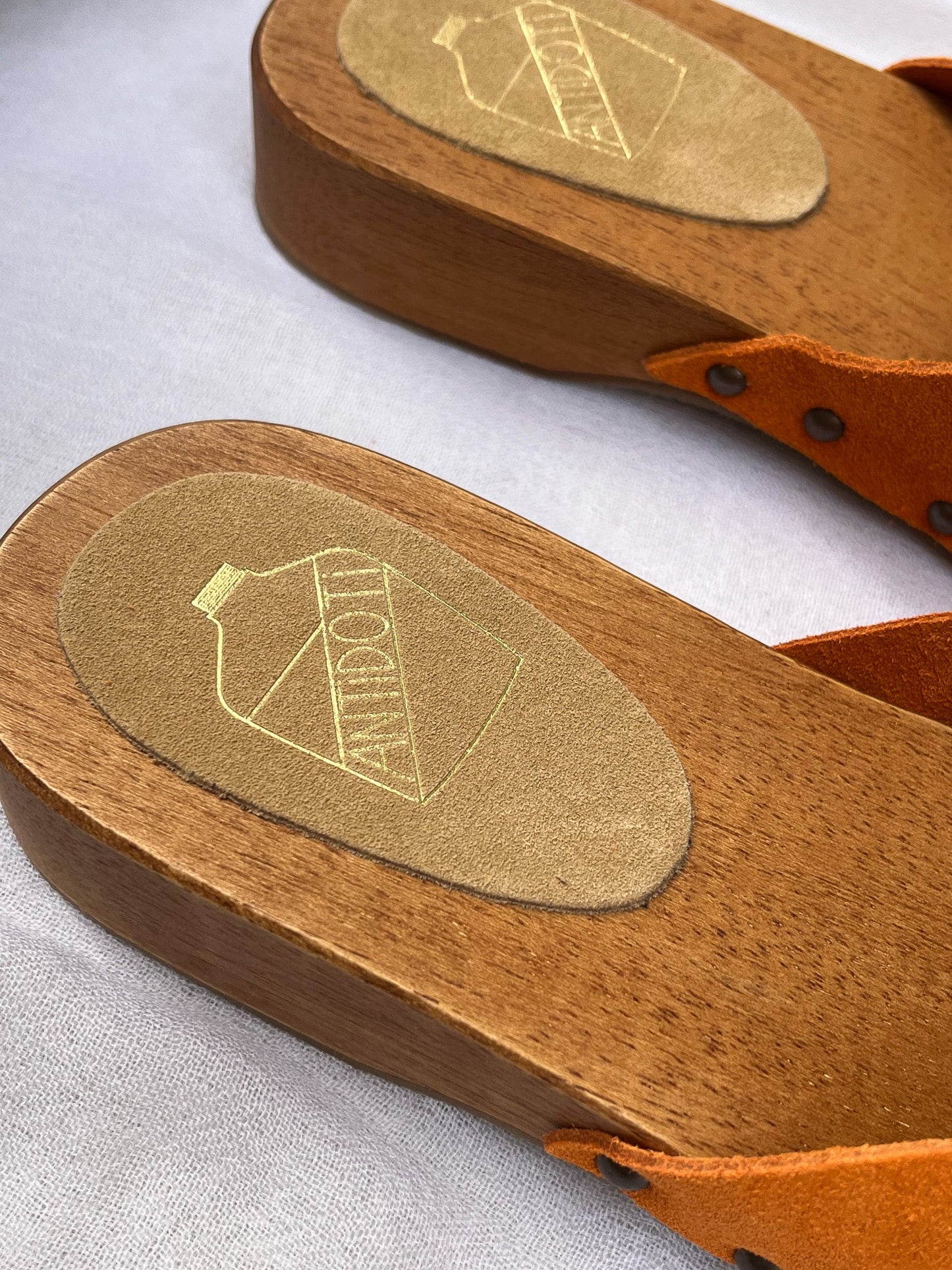 Handmade tangerine velvet clogs by Antidoti with studded sides and wooden sole, crafted in Florence, Italy. Available at House of Woven Stories.