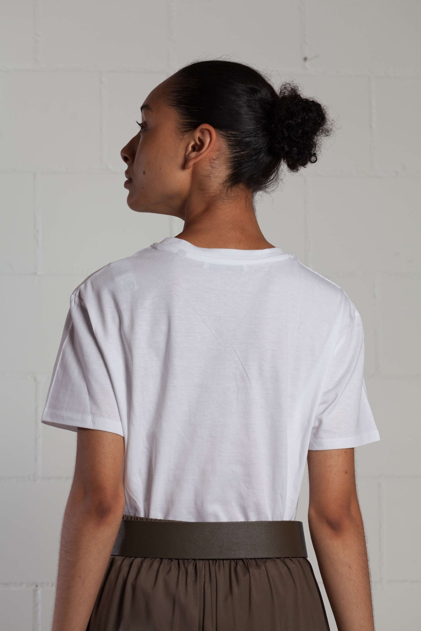 Unisex seamless T-shirt made from certified organic cotton by House of Woven Stories, featuring a minimalist design and exceptionally comfortable fit.