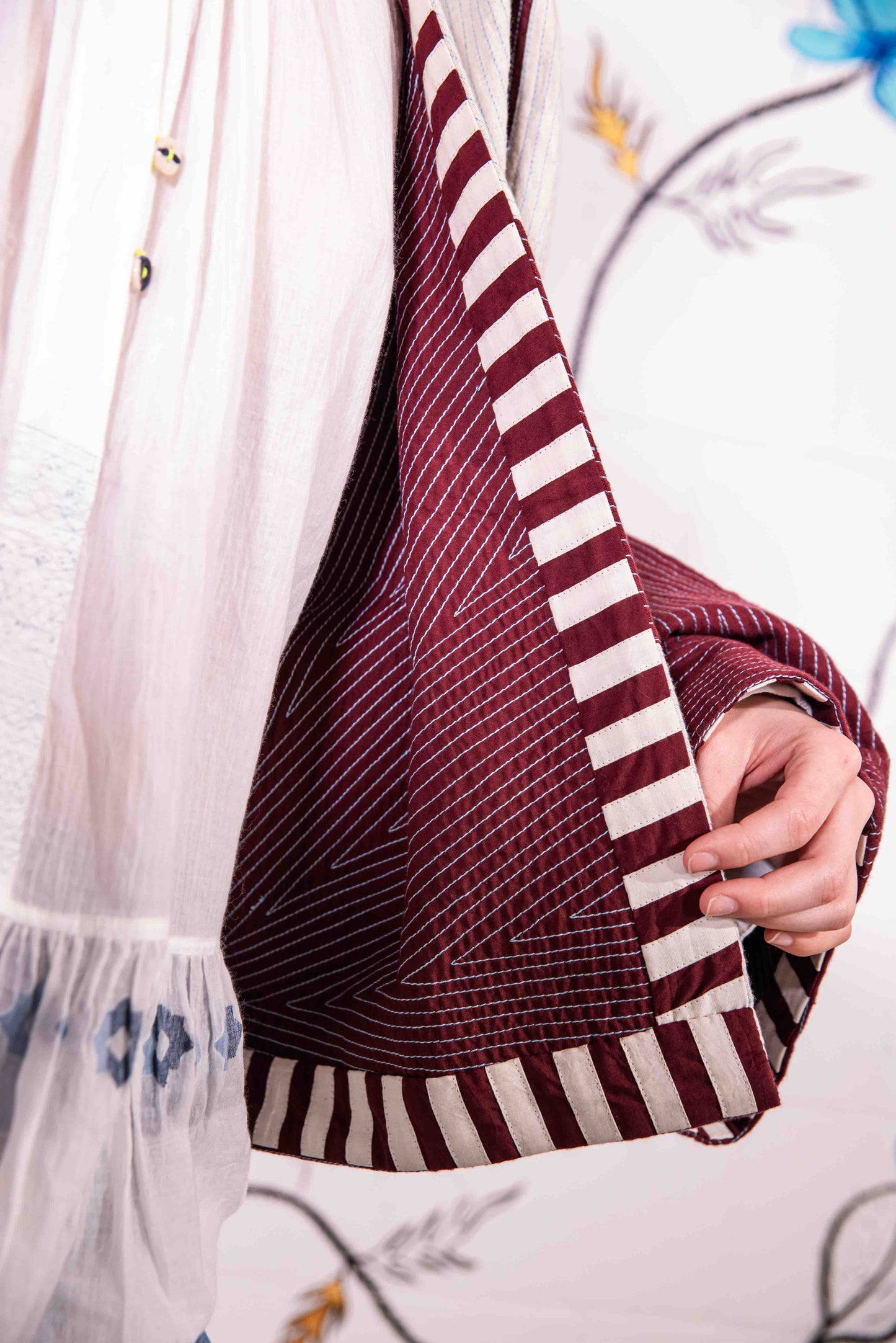 Cropped jacket in heavyweight organic cotton with hand-applied appliqué and embroidery by Ka-Sha. Features fabric button closure and easy-fit silhouette. Ethically handcrafted in India.