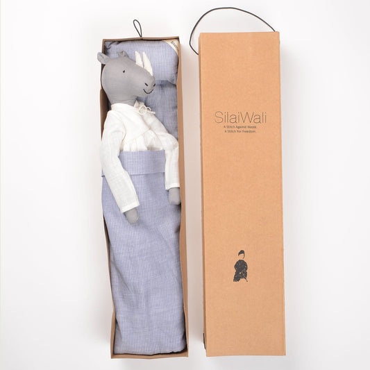 Ura handcrafted rhinoceros cloth doll made from upcycled fabric by SilaiWali, with bedding in foldable box. Available at House of Woven Stories.