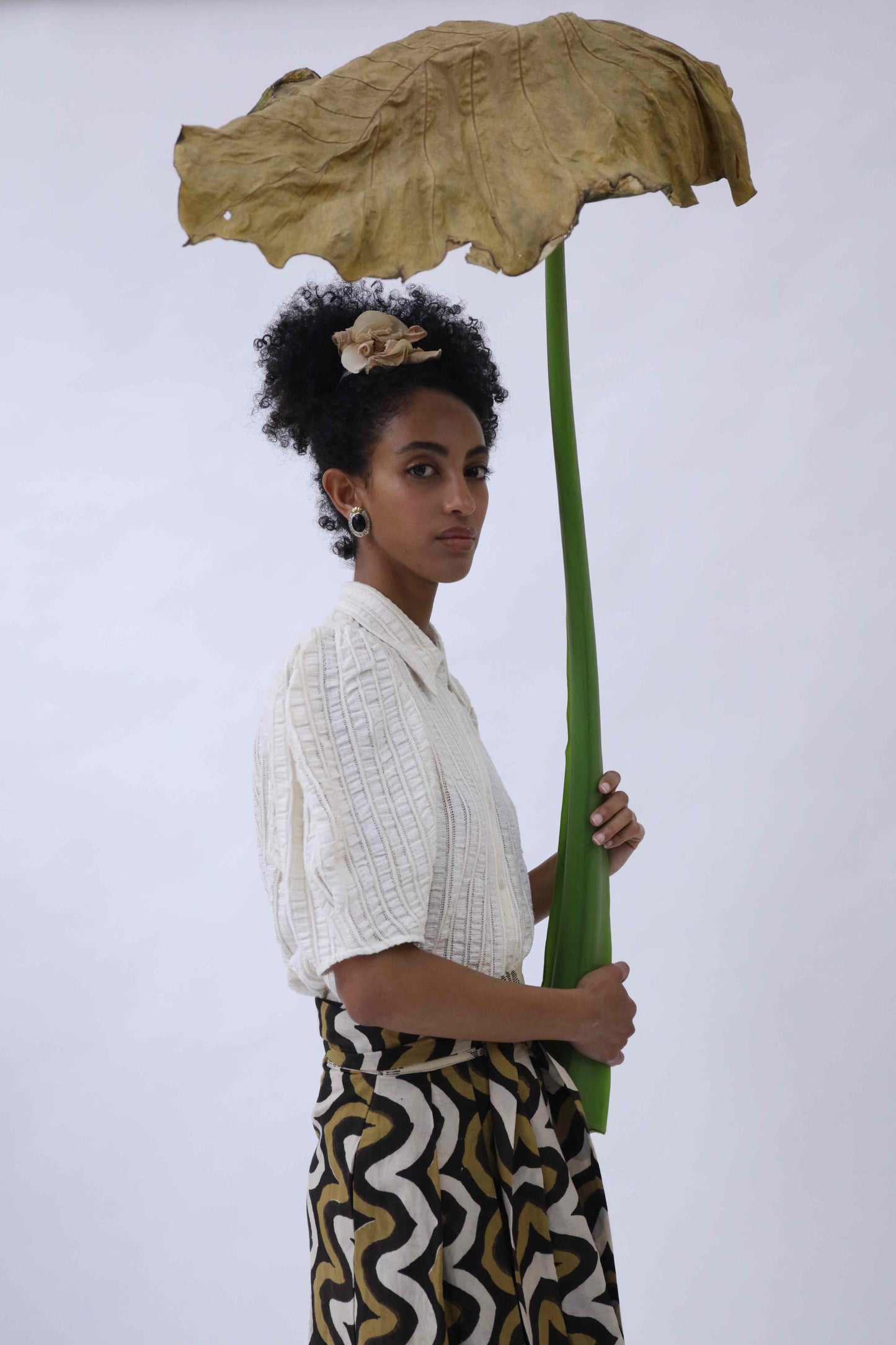 Structured puff-sleeve blouse crafted from upcycled cotton waste and T-shirt scraps, featuring a breathable leno weave. Handmade by Paiwand, combining traditional techniques with sustainable materials for a unique, eco-friendly garment.