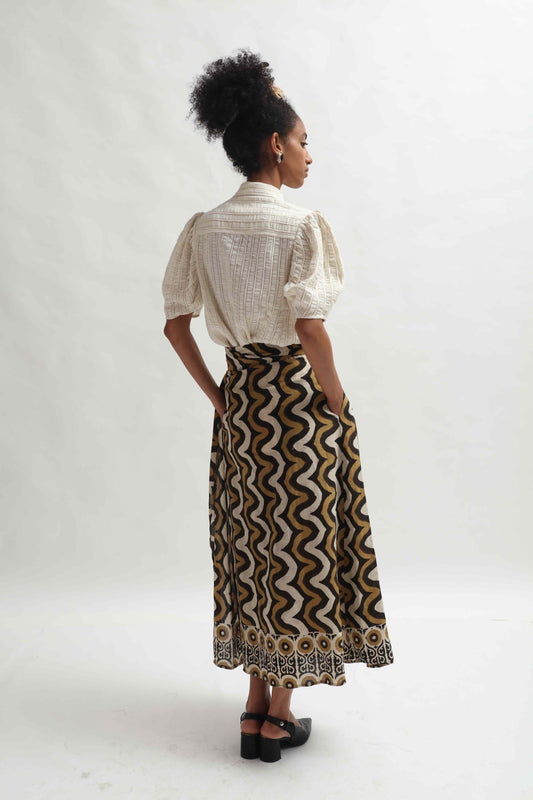 Structured puff-sleeve blouse crafted from upcycled cotton waste and T-shirt scraps, featuring a breathable leno weave. Handmade by Paiwand, combining traditional techniques with sustainable materials for a unique, eco-friendly garment.