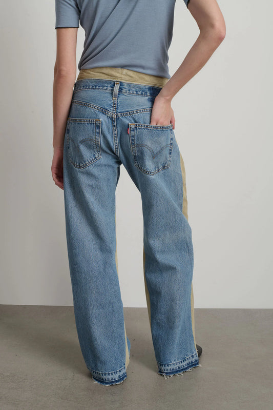 Model is wearing B Sides Double Waistband Rework Jeans in vintage indigo denim with Italian calf suede waistband, mid-rise relaxed fit, 30-inch inseam, unique fade and details, from the curated selection of House of Woven Stories