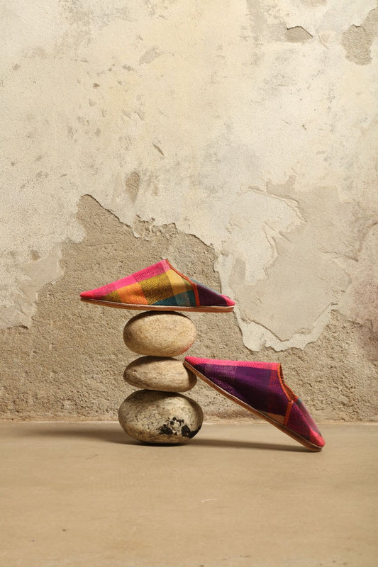 Model is wearing the Baboush in Kelim Fabric by House of Woven Stories, handmade in Marrakesh with colorful handwoven kilim textile and ethically sourced leather sole, showcasing authentic Moroccan craftsmanship.