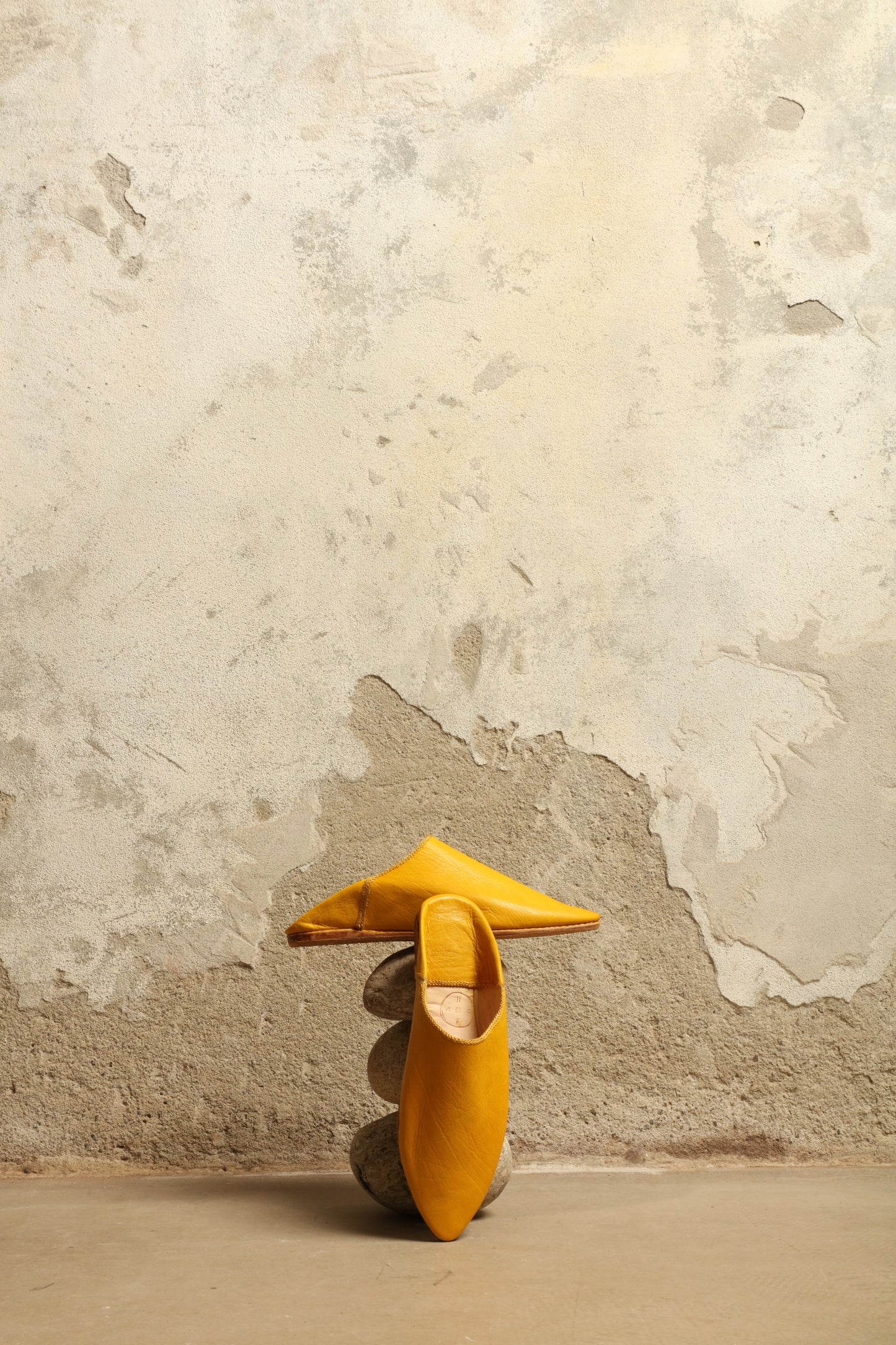 Model is wearing the Baboush in Yellow Leather by House of Woven Stories, handcrafted in Marrakesh from ethically sourced leather with a warm yellow hue, cushioned sole, and timeless Moroccan design.