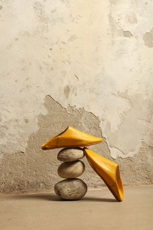 Model is wearing the Baboush in Yellow Leather by House of Woven Stories, handcrafted in Marrakesh from ethically sourced leather with a warm yellow hue, cushioned sole, and timeless Moroccan design.