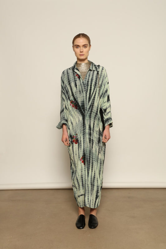 Model is wearing the Barcelona Stone Shade Dress by House of Woven Stories, crafted from 100% pure silk with stone-toned tie-dye and delicate hand-embroidered flowers, featuring a relaxed silhouette and soft collar for artistic, effortless elegance.