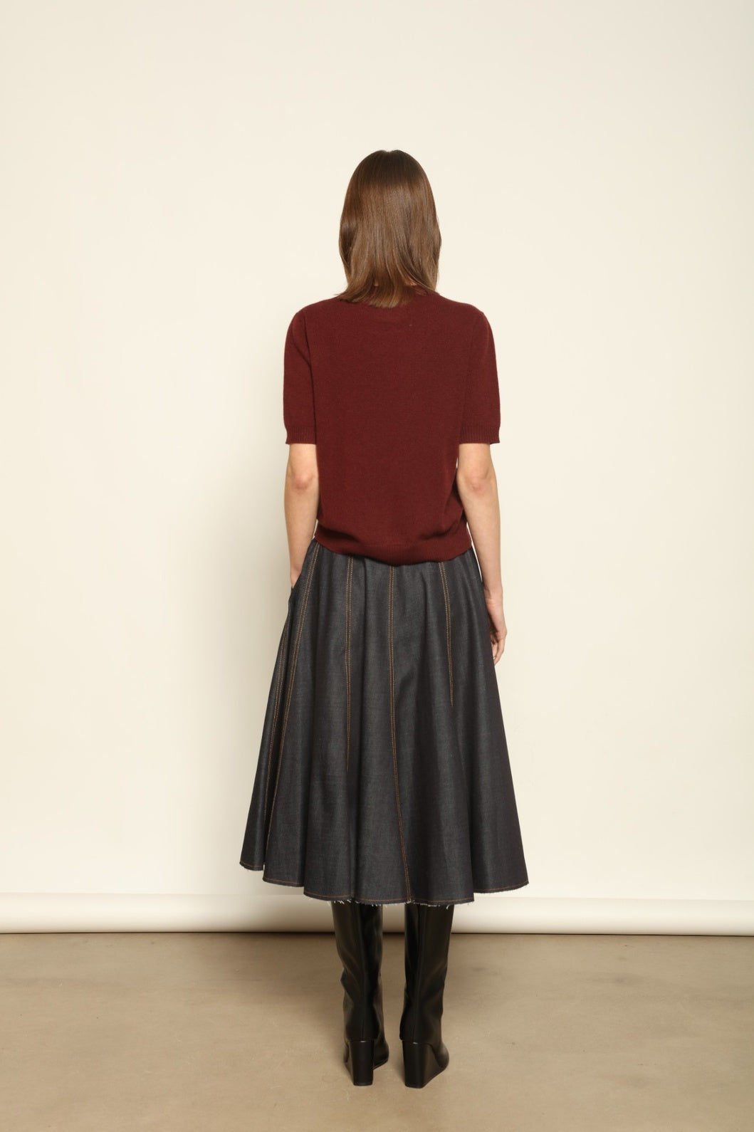 Model wearing the Burgundy Natascha Cashmere Pullover by House of Woven Stories, crafted from 100% pure Inner Mongolia cashmere, featuring a deep burgundy tone, soft breathable texture, round neckline, relaxed fit, and sustainable luxury craftsmanship