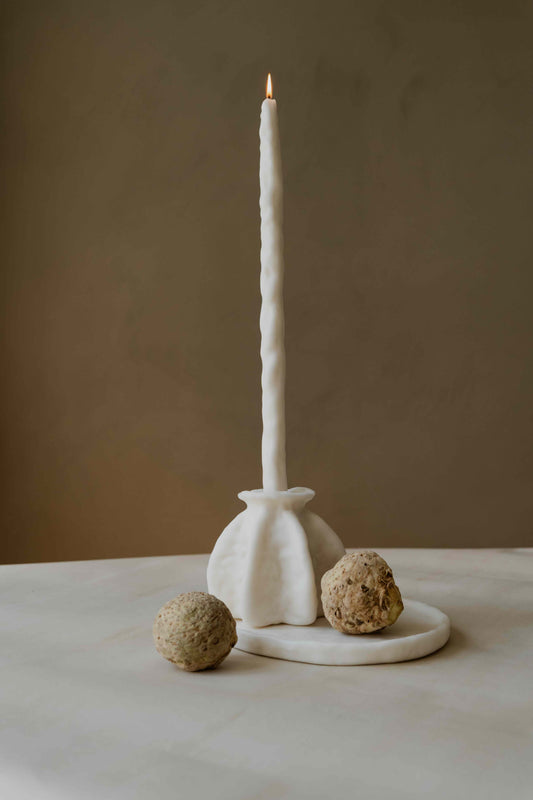 Carambola Low in Cream candle holder by Oberflacht, part of the House of Woven Stories selection, handcrafted from beeswax and paraffin with matching twig candle and subtle variations in colour, shape, and texture.
