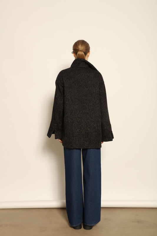 Model is wearing the Carla Maxi Chevron Blazer by House of Woven Stories, crafted from premium Merino wool with chevron weave and an oversized silhouette, combining timeless refinement with modern tailoring.