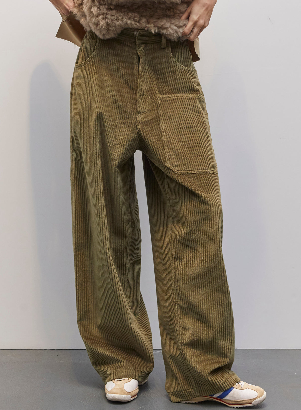 Model wearing the Carla Military Green Velvet Pant by Maison Jejia, part of the House of Woven Stories selection, featuring plush velvet, relaxed tailored silhouette, and deep military green tone