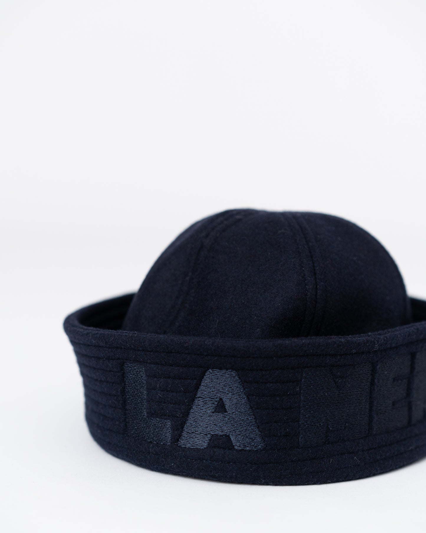 Model is wearing the Chapeau “LA MER” by Les Vacances d’Irina, a handmade cashmere and wool hat lined with Italian viscose and trimmed with a silk ribbon, available at House of Woven Stories.