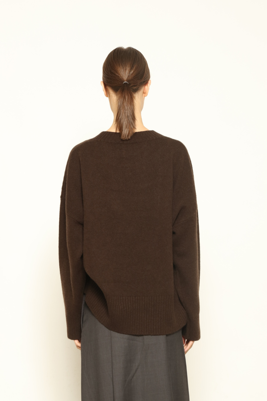 Model is wearing the chocolate Noemi Round Neck Pullover by House of Woven Stories, made from 100% pure Inner Mongolia cashmere, featuring ultra-soft, breathable, durable knitwear, relaxed fit, and timeless luxury craftsmanship