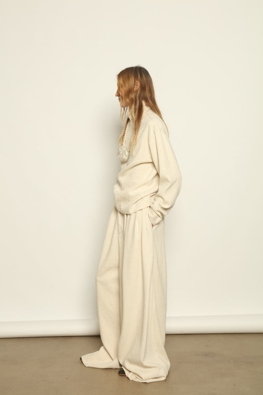 Model is wearing the Ecru Bouclé Solid Turtleneck by Marrakshi Life, part of House of Nomad Stories collection, handwoven cotton bouclé top with relaxed turtleneck, soft texture, and versatile fit