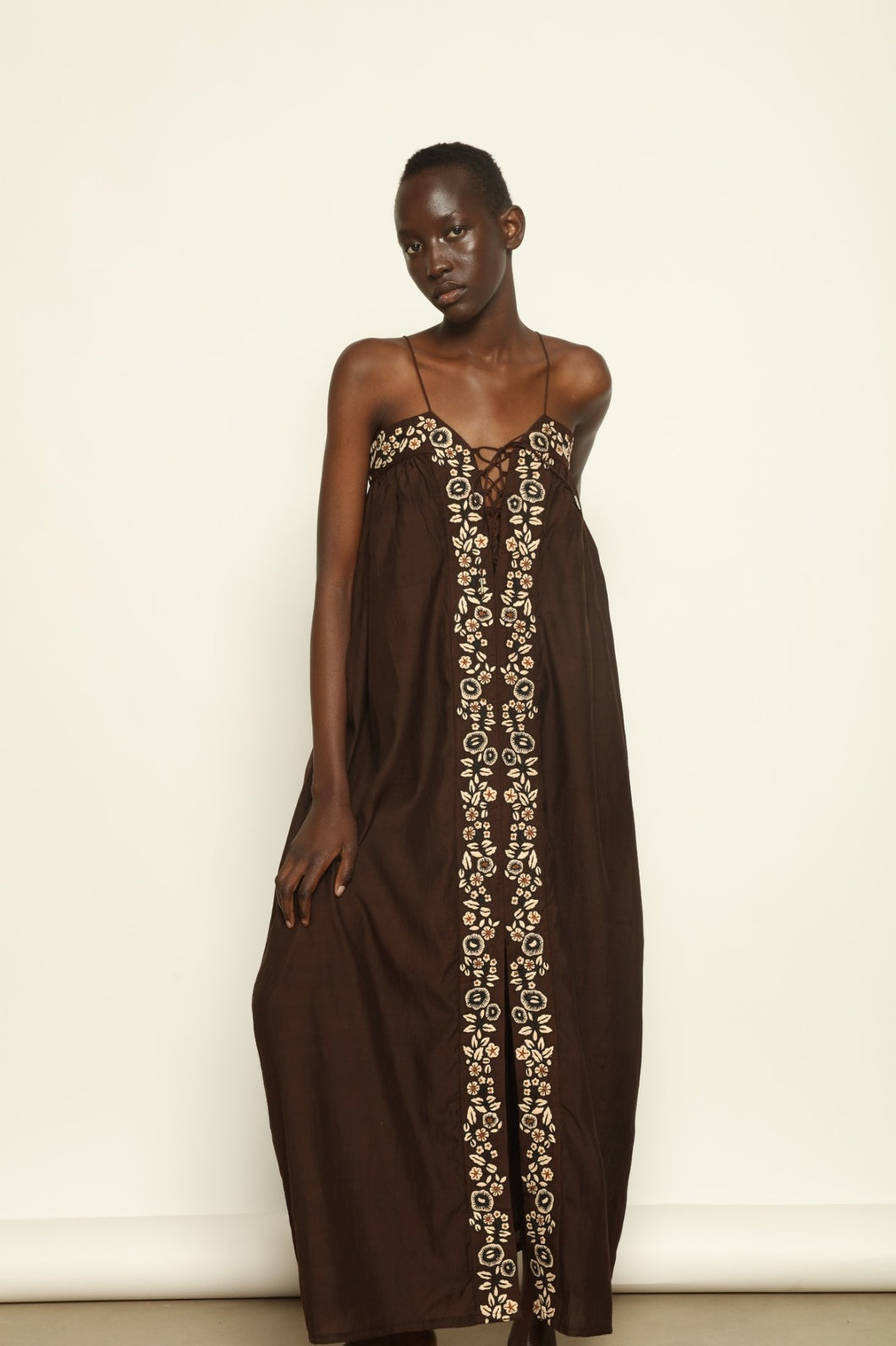 Model is wearing the Flor Brown Linen Dress by Supernaturae x HONS, crafted in heavyweight sustainable linen with a wrap-tie silhouette, earthy brown plant-dyed finish and structured yet breathable form. Made in collaboration with artisan communities in Kutch, Gujarat, this ethical resortwear piece features organic tonal variations and timeless design