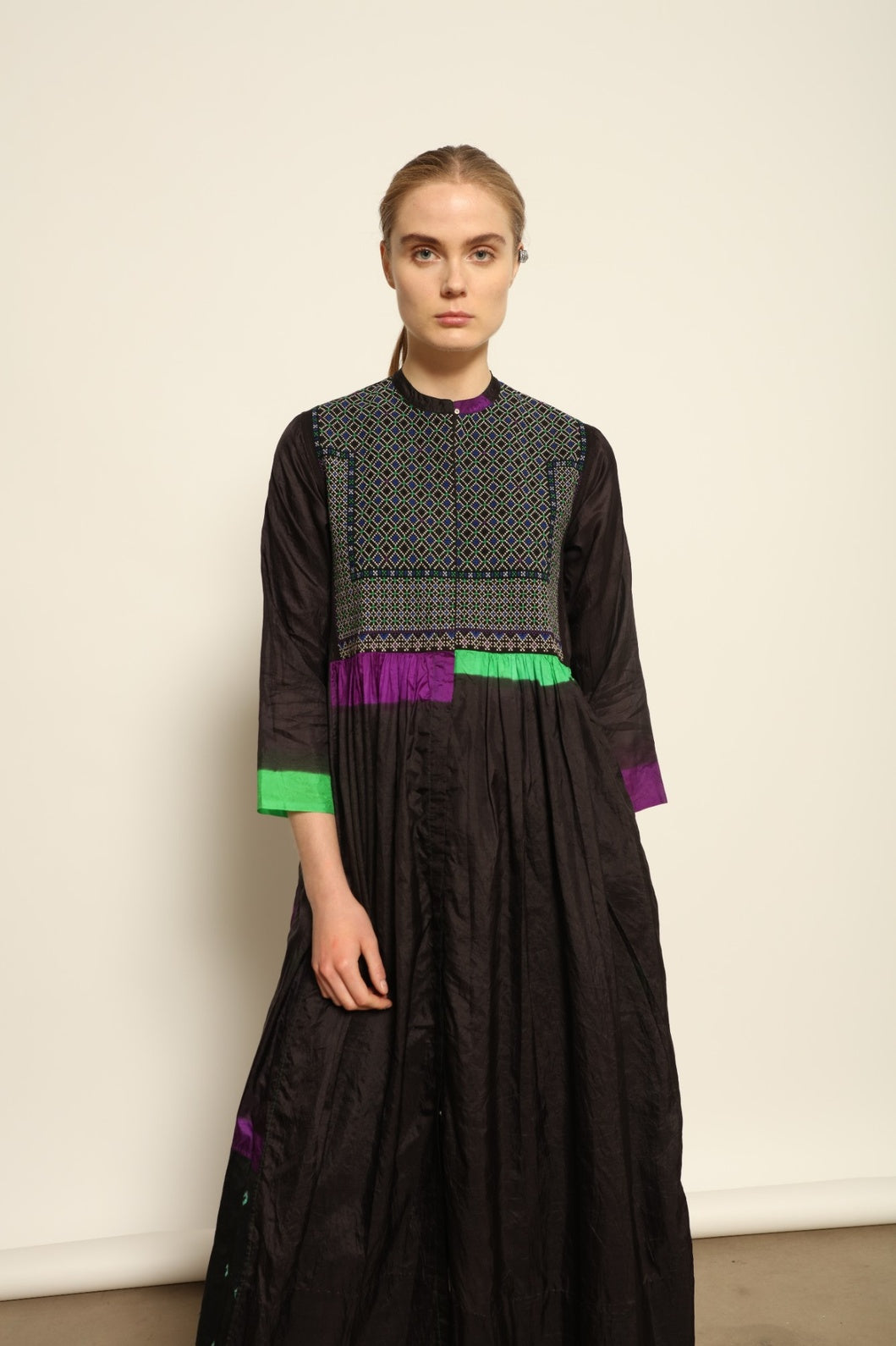 Model is wearing Folklore 10 Handmade Cotton and Silk Dress by Injiri, part of the House of Woven Stories selection, crafted in India from a cotton and silk blend with round neckline, long sleeves, side pockets, and artisanal detailing.