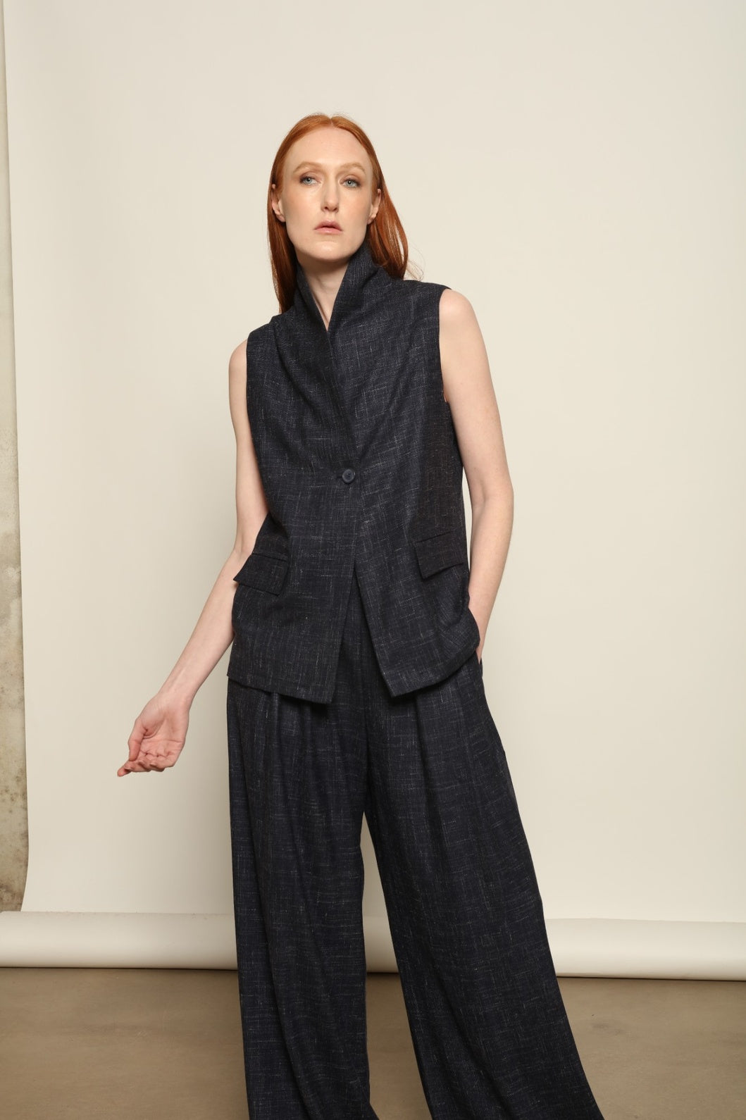Model is wearing the Franca night blue and white gilet from the House of Woven Stories selection, a women’s tailored waistcoat made in Italy in Piedmont with a softly structured silhouette, designed for fluid layering and ethical contemporary fashion.