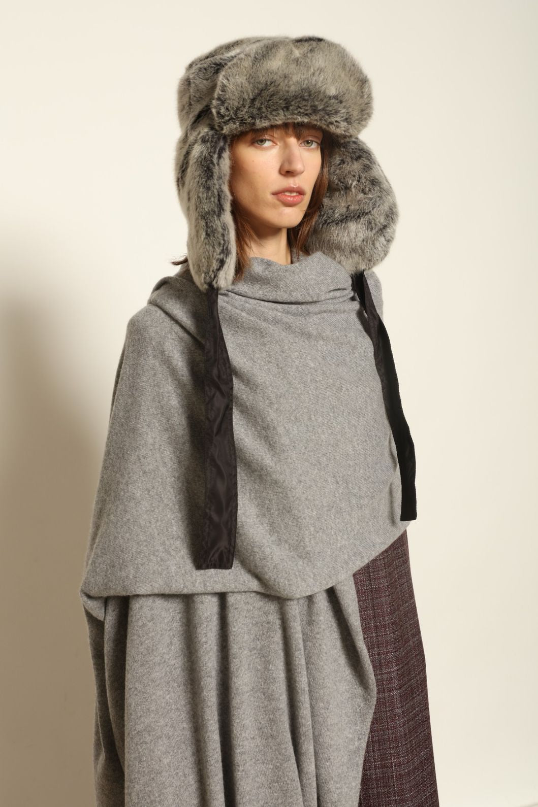 Model wearing the Graphite Leni Cashmere Scarf by House of Woven Stories, made from 100% pure Inner Mongolia cashmere, featuring a soft graphite color, lightweight drape, smooth texture, lasting warmth, and sustainable luxury craftsmanship