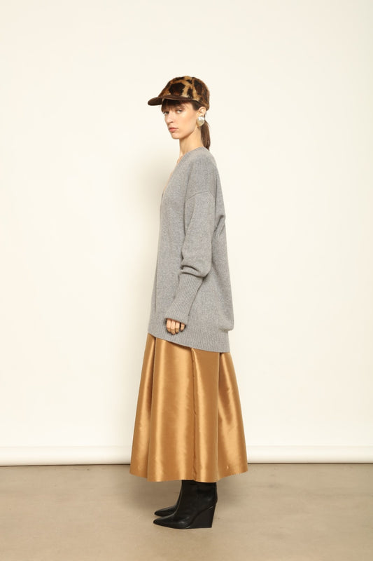 Model wearing the Graphite Nina V-Neck Long Sweater by House of Woven Stories, crafted in Italy from 100% pure Inner Mongolia cashmere, featuring a deep graphite hue, elongated silhouette, soft drape, and timeless sustainable knitwear design